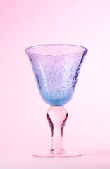 Stock photo of a wine glass on a pink background