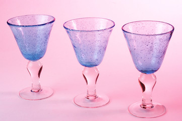 Stock photo of wine glasses on a pink background