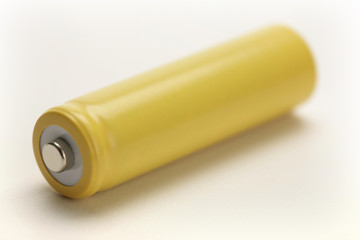 one yellow rechargeable battery on white background