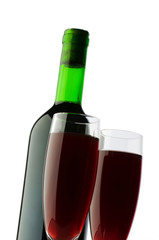 Bottle and wine glass on reflective background