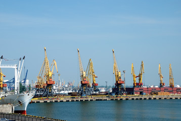 Fototapeta premium The trading seaport with cranes, cargoes and ship