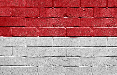 Flag of Monaco on brick wall
