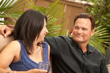 Naklejka premium Attractive Hispanic and Caucasian Couple Drinking Wine