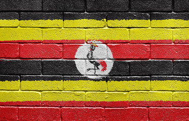 Flag of Uganda on brick wall