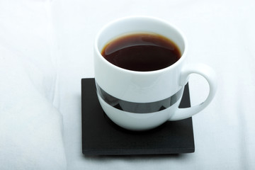 Cup on bed at bedroom