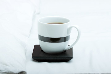 Cup on bed at bedroom