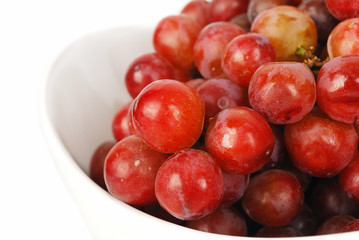 Red grapes in the bowl closeup.