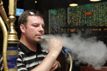 The man resting in a hookah house