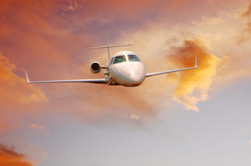 airplane in air on sunrise sky