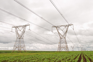 Electricity pylons against a stormy sky