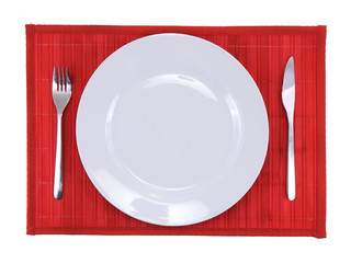 Table appointments(arrangement) of flatware on bamboo mat.