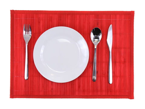 Table appointments(arrangement) of flatware on bamboo mat.