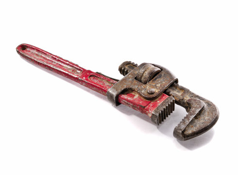 Old and rusty Stilson wrench with red aged handler