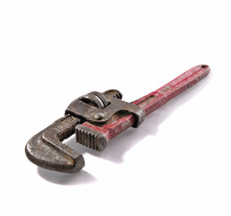 Old and rusty Stilson wrench with red aged handler