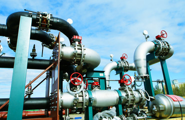 industrial pipelines on pipe-bridge against blue sky