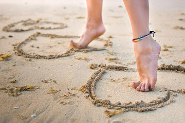 womans legs on beach