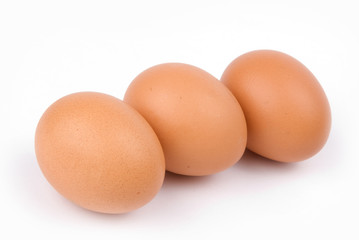 Three chicken eggs on a white background