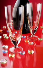 Glass of red wine with glass and bottle
