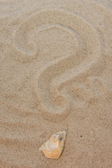 Question sign in sand