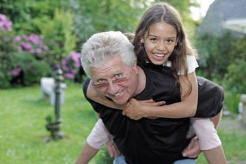 Girl piggyback on her grandpa