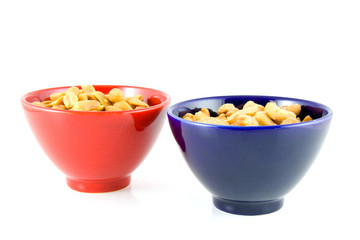 Colorful bowls with nuts isolated on white background