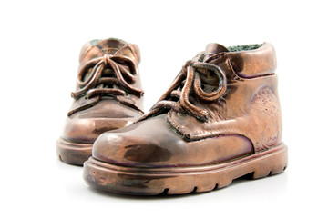 pair of bronze kids shoes isolated on white background