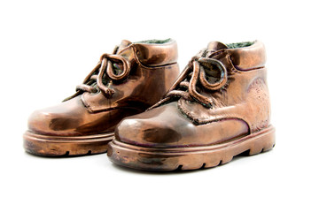 pair of bronze kids shoes isolated on white background