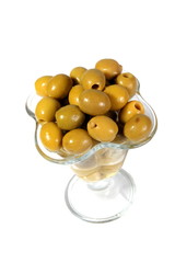 Green olives in a glass vase on a white background