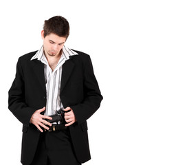 Portrait of young male bodyguard looking at gun in pants