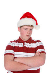 teenage boy wearning santa hat and looking unhappy about it