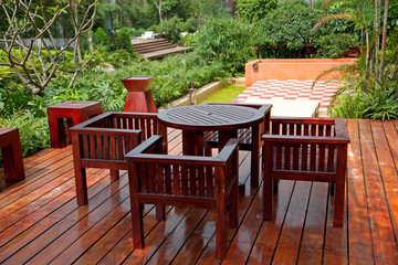 House patio with wooden table and chairs - Powered by Adobe