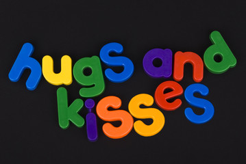 Hugs and kisses colourful lettering