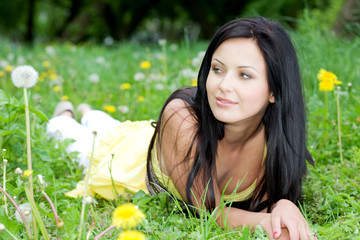 Portrait of beautiful woman laying on grass