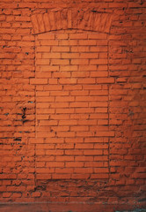 old orange brickwall with architrav of a door