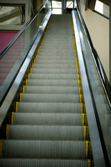 escalator leading upwards in a shopping mall