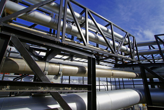 industrial pipelines on pipe-bridge against blue sky