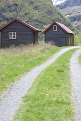 Fototapeta na wymiar mountain road to houses with wood