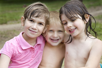 two little girl and one boy hugging. Friends