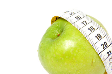 Green apple with measure-tape isolated on white background