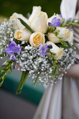 Bride in dress holding beautiful bouquet