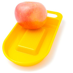Yellow juicer with apple isolated on white
