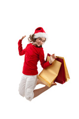 Christmas time, girl holding shopping bags jumping isolated