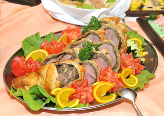 Stuffed meat decorated with tomato orange and lettuce