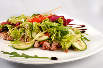 A plate of pork with vegetables. File includes clipping path for