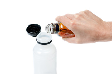 Pouring alcohol in water bottle