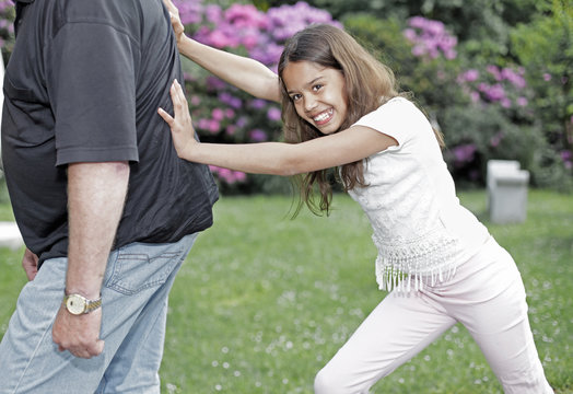Girl pushing her grandpa