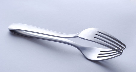 Two forks laying one over another