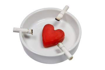 Cigarette stubs and a heart in a white ash-tray