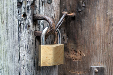 Padlock on Distressed Wood Door