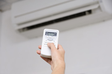 Hand of woman includes air-conditioner